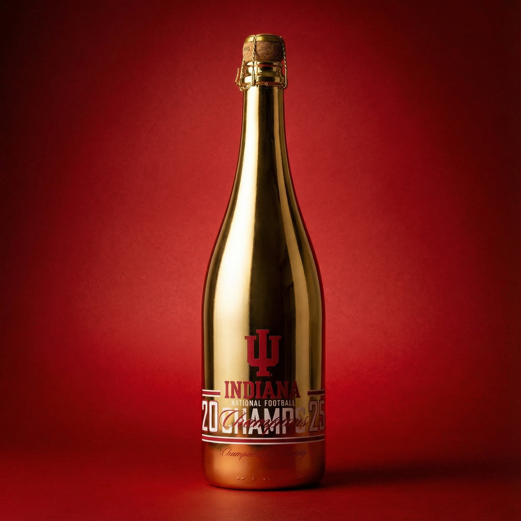 Gold wine bottle with red Indiana University 2025 National Football Champs label on a red background