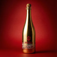 Gold wine bottle with red Indiana University 2025 National Football Champs label on a red background