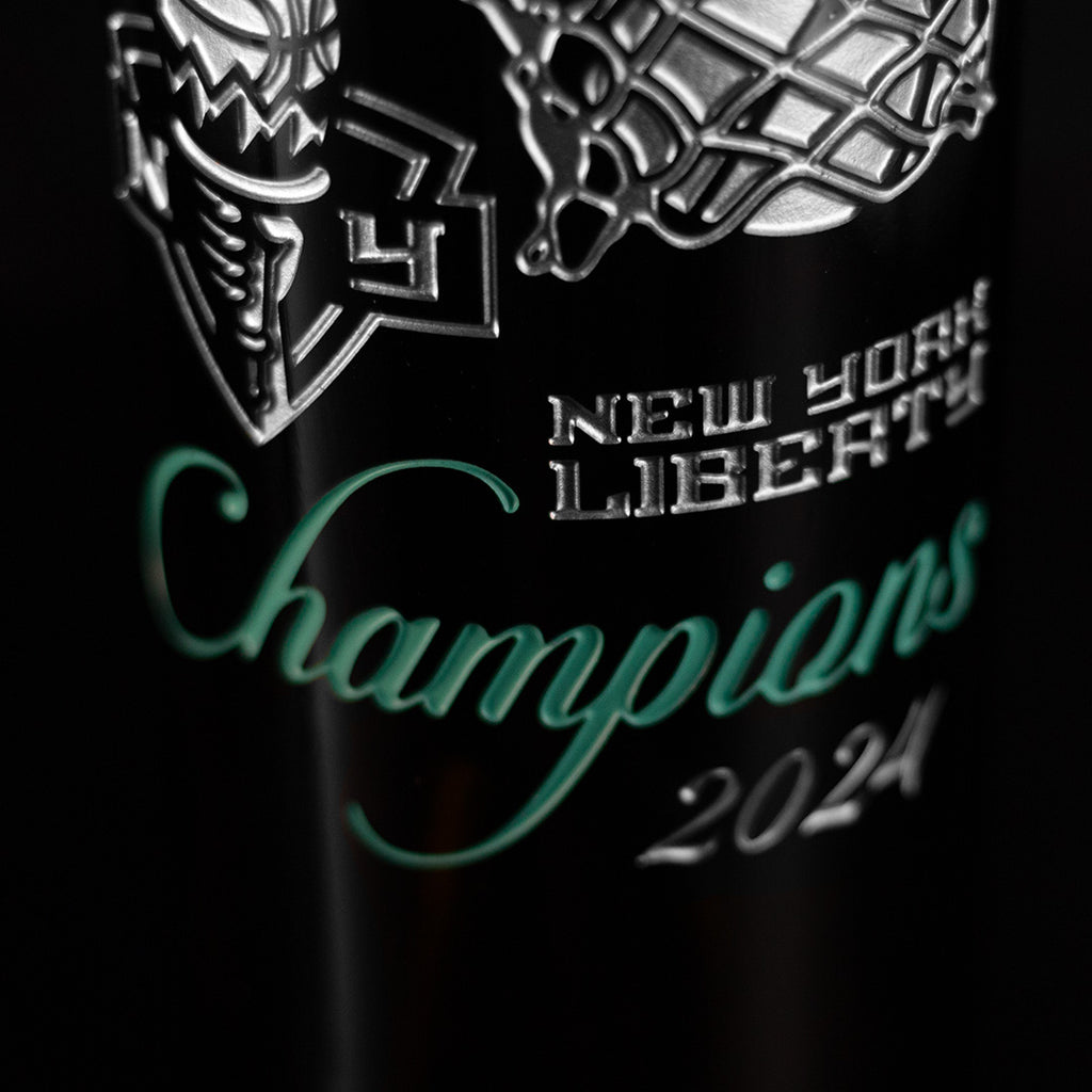 New York Liberty team logo, 2024 Champions etched on a Mano's Wine bottle