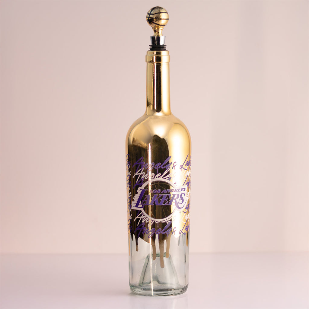 Los Angeles Lakers gold drip wine bottle with gold basketball wine bottle topper in the bottle
