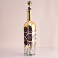 Los Angeles Lakers gold drip wine bottle with gold basketball wine bottle topper in the bottle