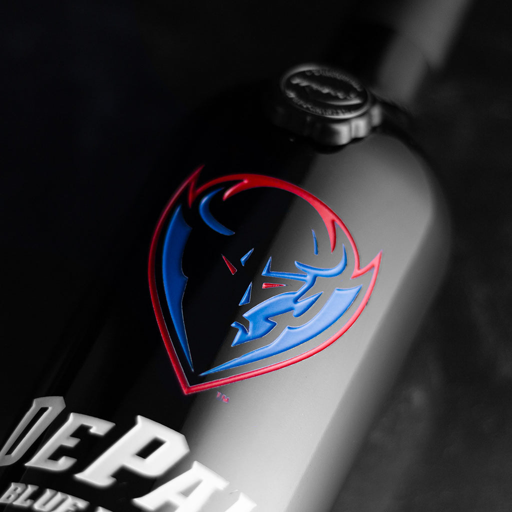Close up of Mano's Wine cabernet sauvignon wine bottle etched with DePaul University Blue Demons logo
