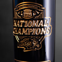 Close up of gold etched wine bottle with Division 1 Football 2024 National Champions and North Dakota State University Bisons logo