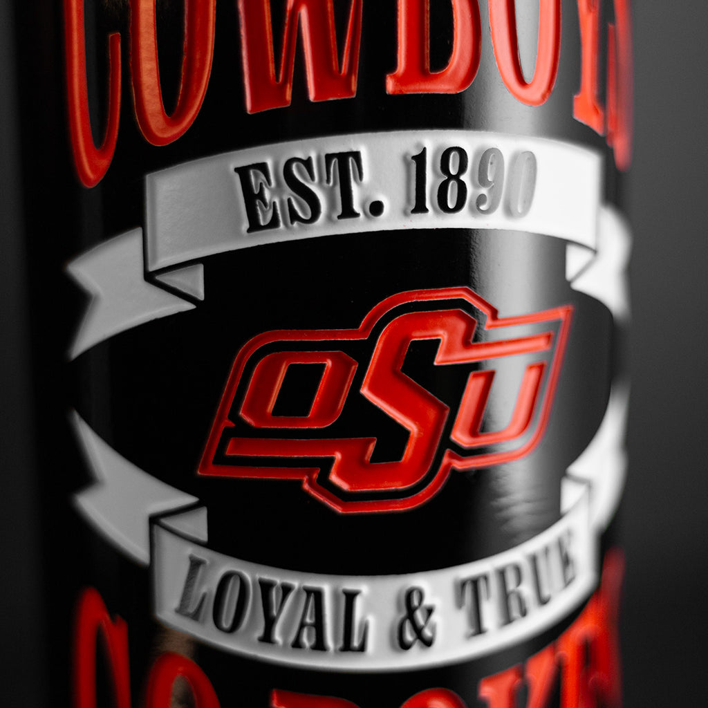 Close up of a bottle of  wine etched with Oklahoma State Cowboys, GO POKES, established 1890, OSU logo, and Loyal & True