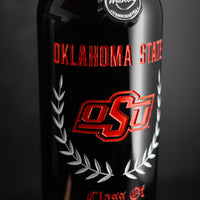 Close up view of red wine bottle etched with Oklahoma State, orange OSU logo, graduating class and custom name