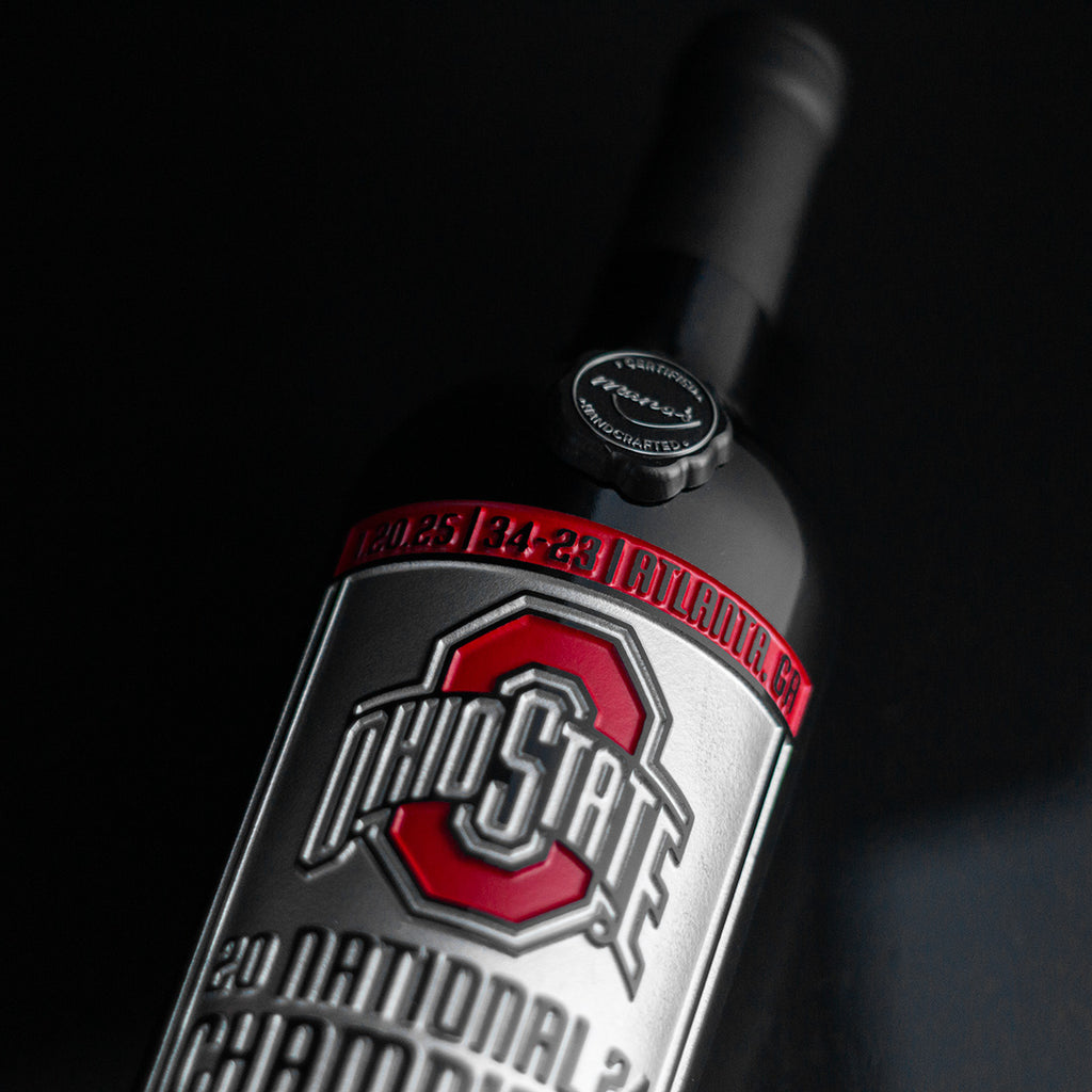 Close up of the Ohio State University 2024 National Champions Banner etched wine bottle from Mano's Wine