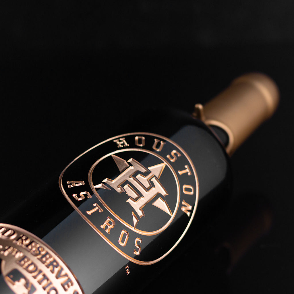 Gold Houston Astros logo etched on wine bottle dipped in gold wax