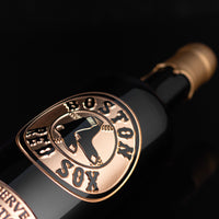 Gold Boston Red Sox logo etched on wine bottle dipped in gold wax