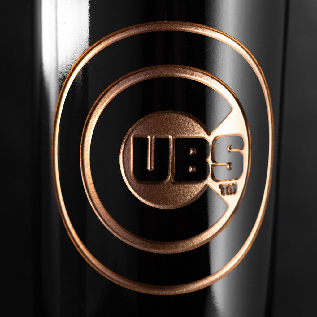 Close up image of Chicago Cubs etched in gold on a Mano's Wine bottle