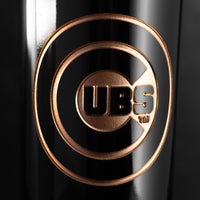 Close up image of Chicago Cubs etched in gold on a Mano's Wine bottle