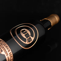 Gold Chicago Cubs logo etched on wine bottle dipped in gold wax