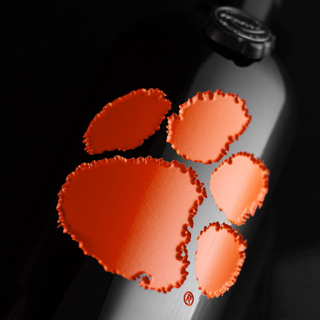 Close up of Clemson University Tiger Paw Logo Etched Wine Bottle from Mano's Wine