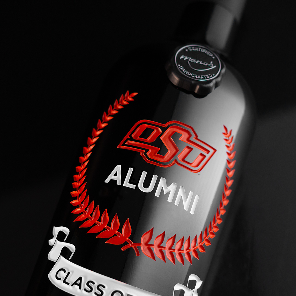 Close up view of the Oklahoma State Custom Alumni Association Etched Wine bottle from Mano's Wine