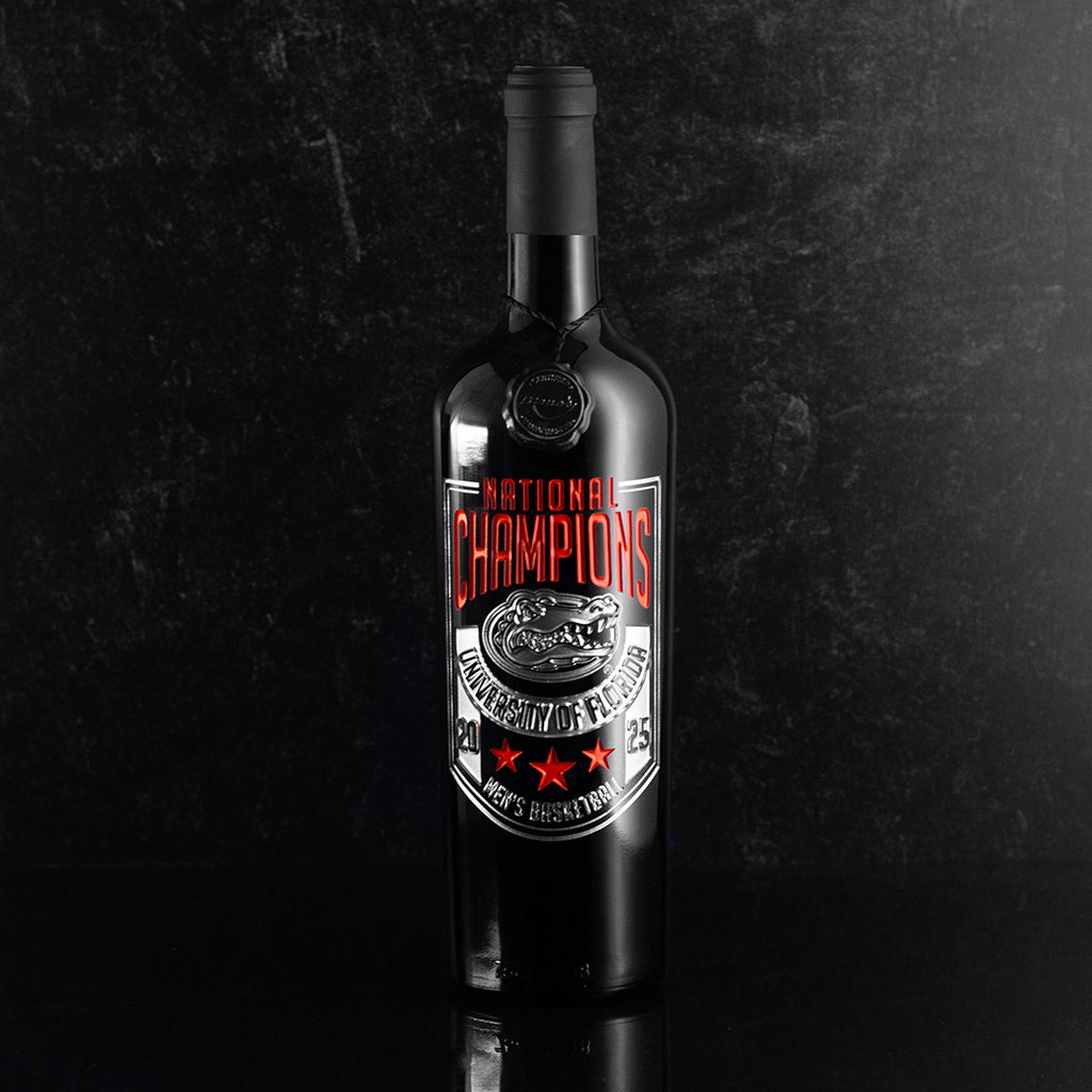 Orange and silver Mano's Wine University of Florida 2025 National Champions Banner Etched Wine bottle