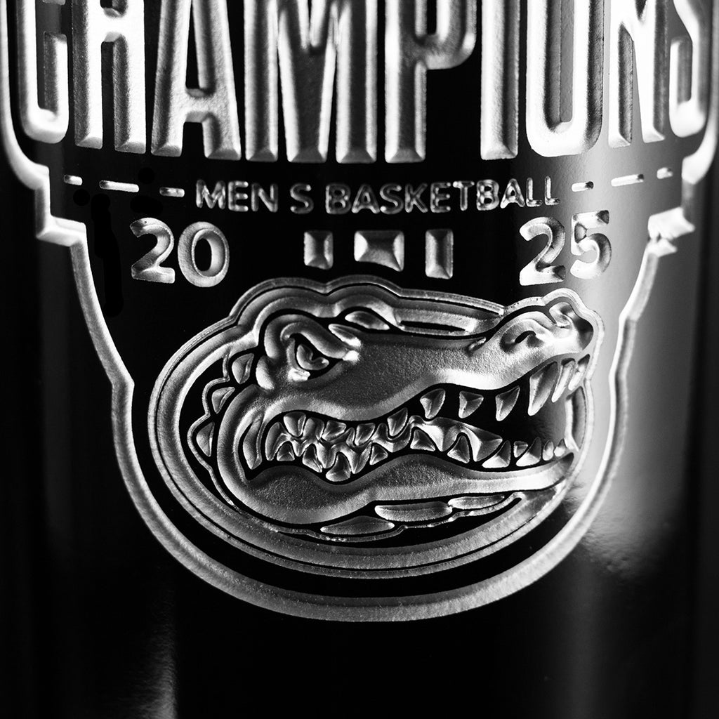 Close up of Mano's Wine etched bottle featuring silver University of Florida Gators logo and text 2025 National Basketball Champions