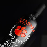 Close up of orange Clemson University custom alumni etched wine bottle from Mano's Wine