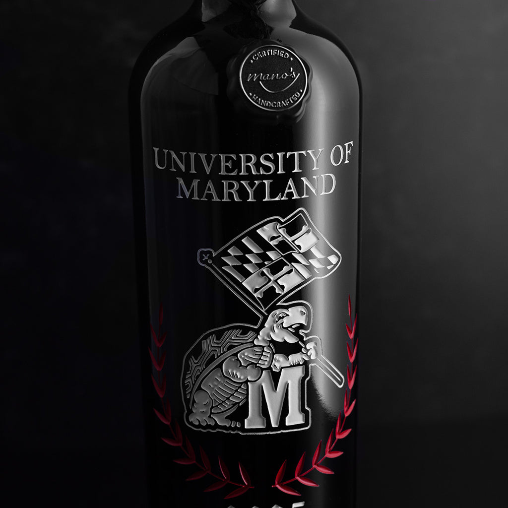 Close up look at University of Maryland Custom Alumni Etched Wine bottle from Mano's Wine with white terrapin waving Maryland flag