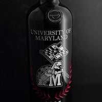 Close up look at University of Maryland Custom Alumni Etched Wine bottle from Mano's Wine with white terrapin waving Maryland flag