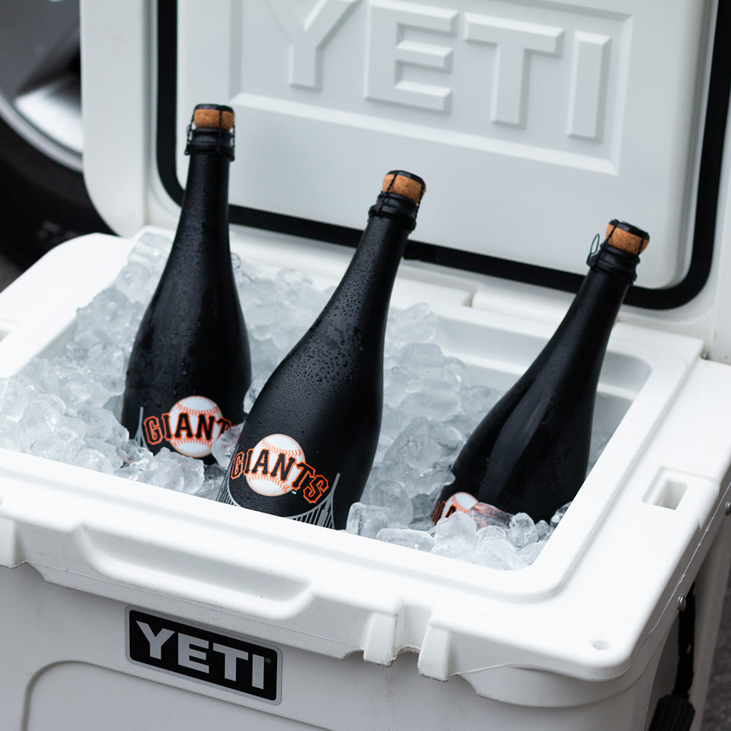 Three Mano's Wine bottles of San Francisco Giants bubbly wine on ice in a YETI cooler