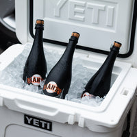 Three Mano's Wine bottles of San Francisco Giants bubbly wine on ice in a YETI cooler