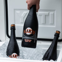 Mano's Wine bottles of San Francisco Giants bubbly wine bottles in a cooler with a hand grabbing a bottle out from the cooler
