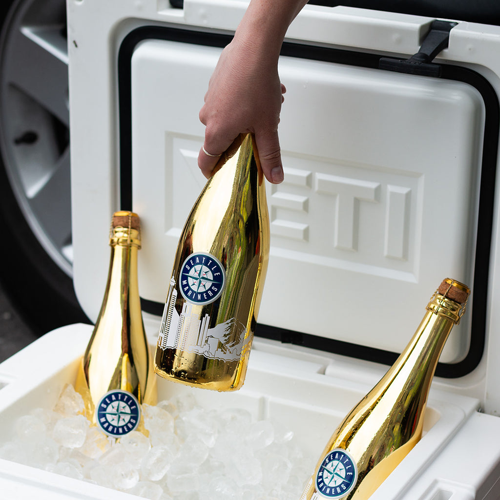 Mano's Wine bottle of Seattle Mariners bubbly wine being pulled out from the ice in a cooler