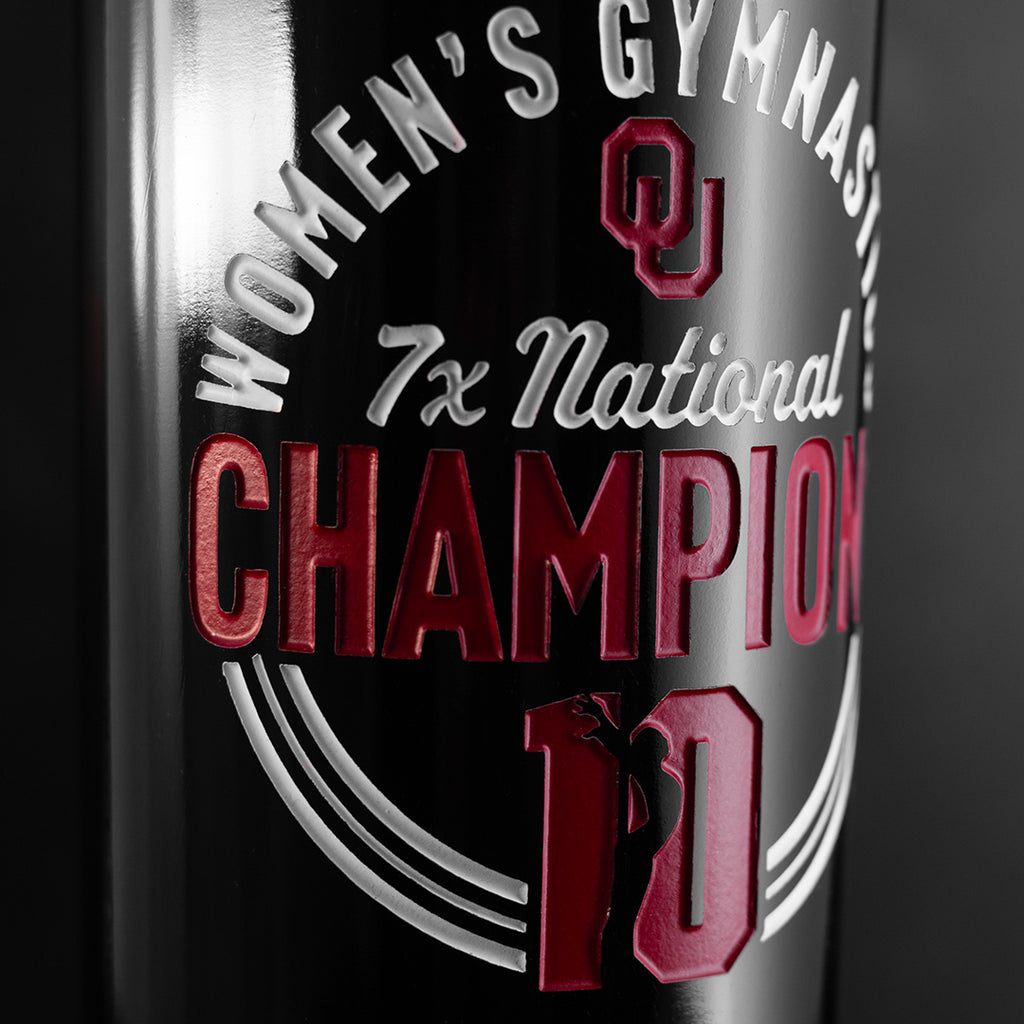 Close up view of the University of Oklahoma Women's Gymnastics 7x Champions Etched Wine bottle