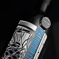Close up of OKC Thunder etched cabernet sauvignon wine bottle with silver and OKC Thunder blue colors