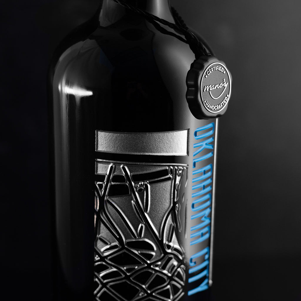 Close up of silver net and basketball hoop etched on OKC Thunder wine bottle from Mano's Wine