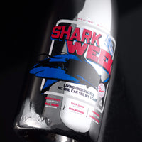 Close up of Mano's Wine bubbly bottle featuring red and blue Shark Week design
