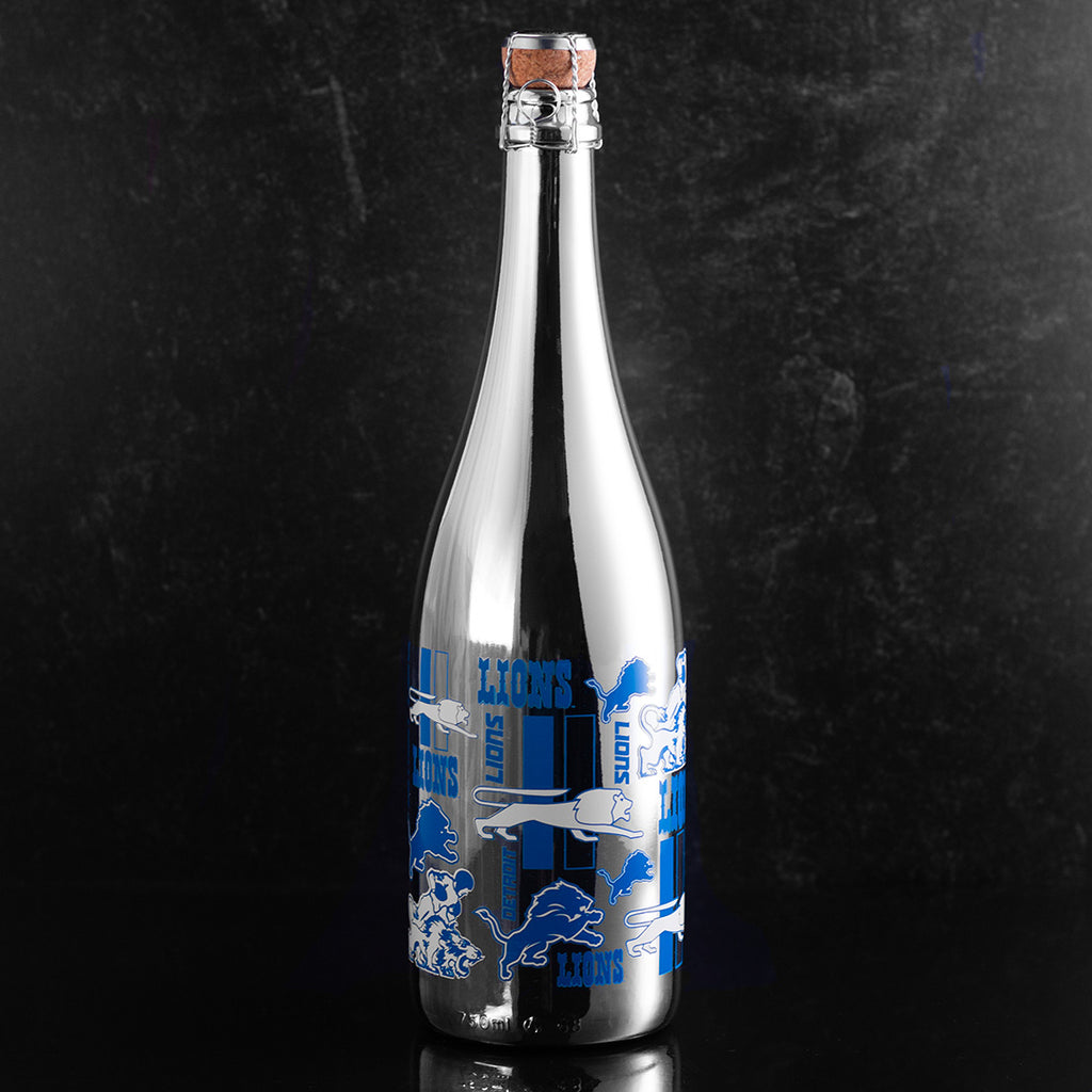 Silver bottle of bubbly wine featuring Detroit Lions logos and text from Mano's Wine