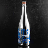 Silver bottle of bubbly wine featuring Detroit Lions logos and text from Mano's Wine
