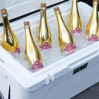 Metallic gold Ohio State University 2024 National Champions bubbly wine bottles in ice in a YETI cooler