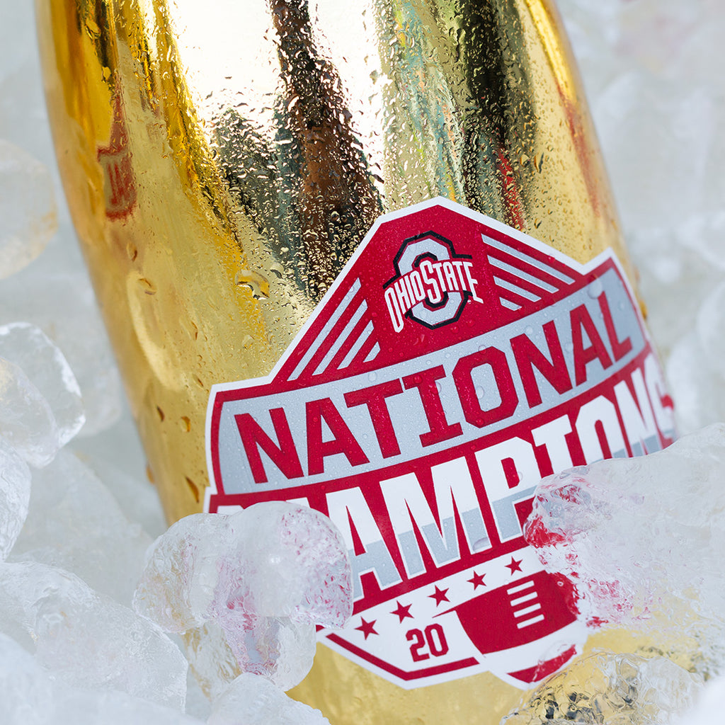 Close up view of Ohio State University 2024 National Champions Gold Metallic Bubbly Wine Bottles