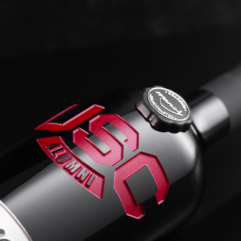 Close up view of a Mano's Wine bottle etched with USC Alumni for University of South Carolina