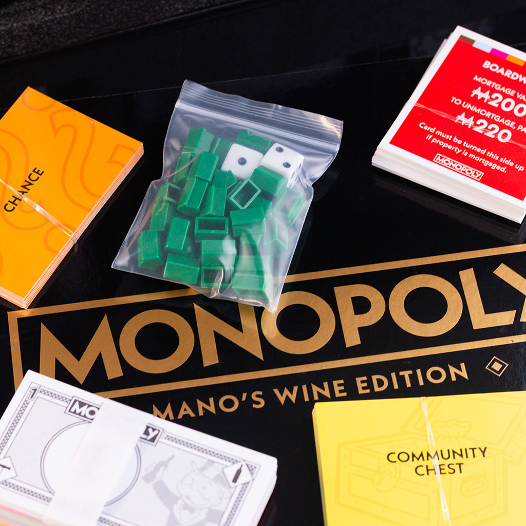 Monopoly property pieces, cards, and money in game set