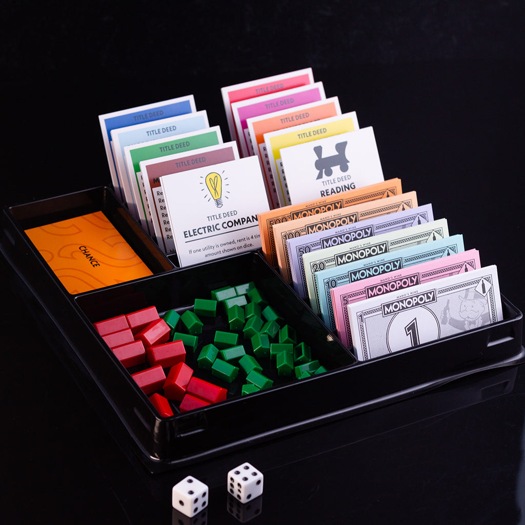 Monopoly property pieces, cards, dice, and money in game set
