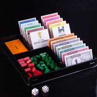 Monopoly property pieces, cards, dice, and money in game set