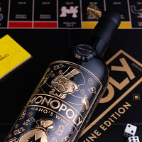 Monopoly Mano's Wine bottle with game pieces and dice on board