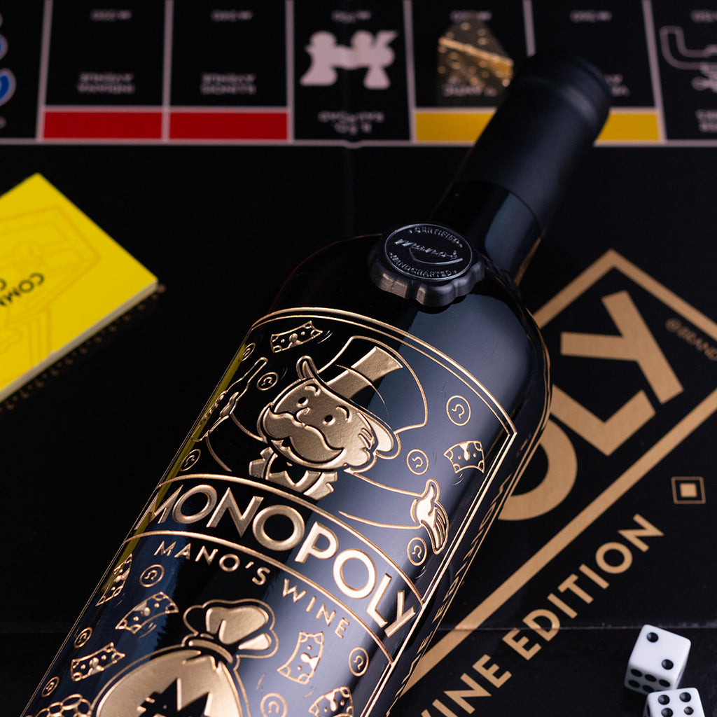 Monopoly Mano's Wine bottle with game pieces and dice on board
