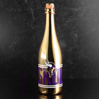 Mano's Wine gold bottle of Blanc de Blanc bubbly wine with Minnesota Vikings logo and purple SKOL text