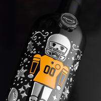 Close up of the Steelers 2025 limited edition holiday etched wine bottle with a football playing nutcracker