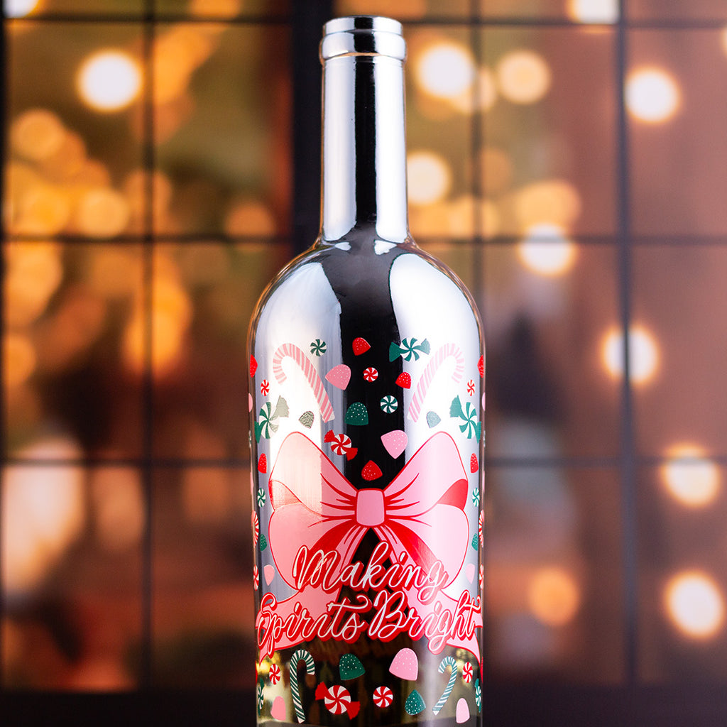 Decorative wine bottle with festive design and 'Making Spirits Bright' text