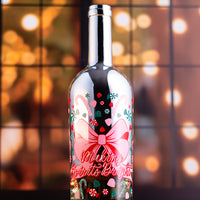 Decorative wine bottle with festive design and 'Making Spirits Bright' text