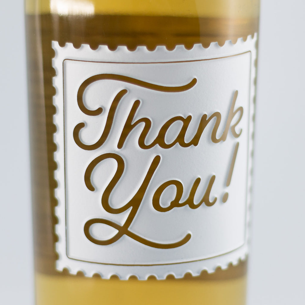 Close up of Thank You Stamp Chardonnay Custom Etched Wine bottle from Mano's Wine