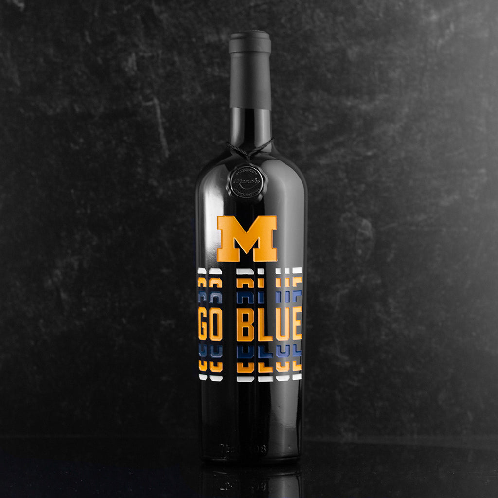 University of Michigan logo and Go Blue text deep etched and hand painted on Mano's Wine bottle