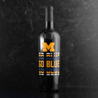 University of Michigan logo and Go Blue text deep etched and hand painted on Mano's Wine bottle
