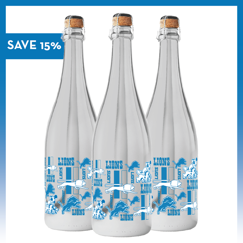 Mano's Wine Detroit Lions Logo Evolution Metallic Silver Bubbly wine bottle featuring "SAVE 15%" text