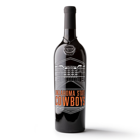 A bottle of Mano's Handcrafted Reserve California Cabernet Sauvignon wine etched with the Oklahoma State University Boone Pickens Stadium logo and the word Cowboys