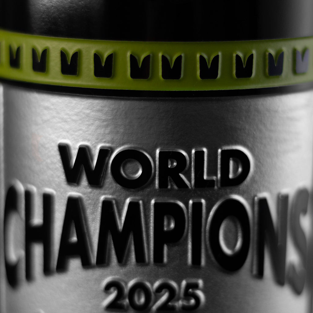 Mano's Wine silver and light green bottle etched with World Champions 2025